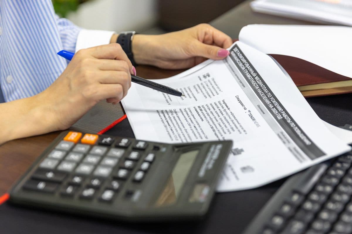 A calculator and documents used for payroll processing