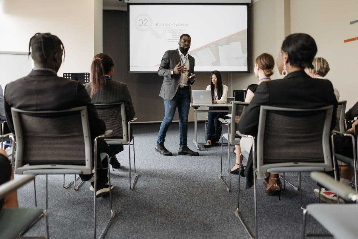 A manager leading a team discussion around a table