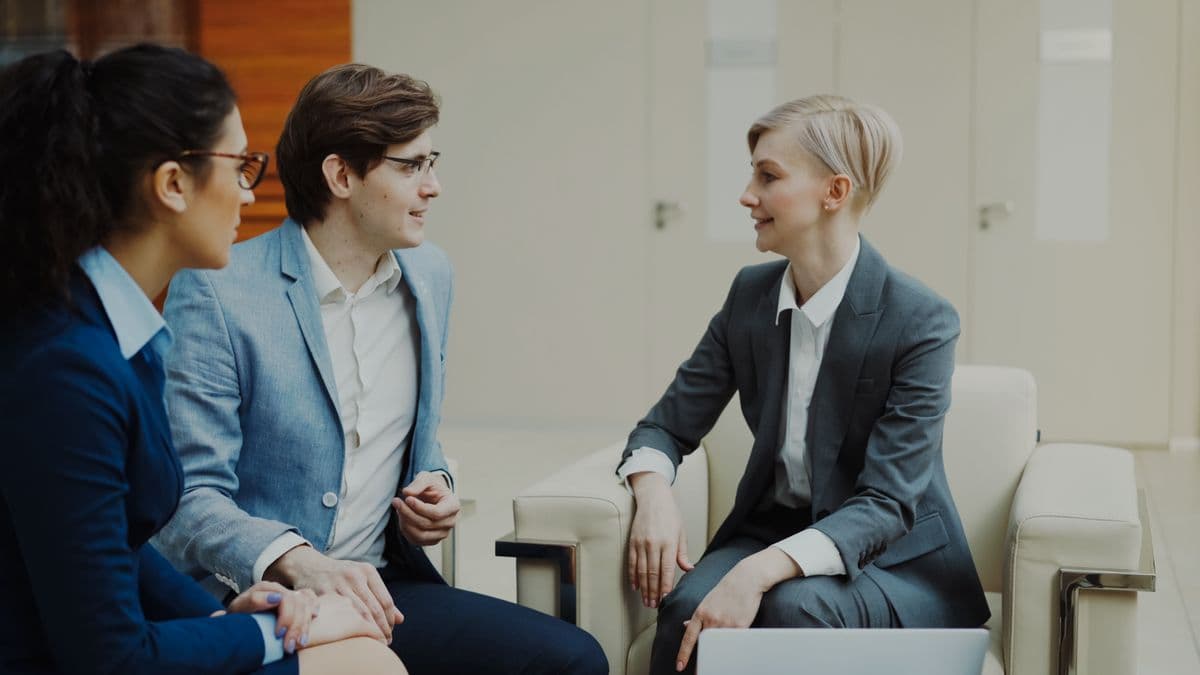 A hiring team interviewing a candidate in an office